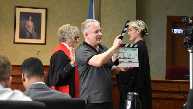 The Honourable Justice Deborah Gass, now retired, plays the role of the judge in the courtroom scenes. 