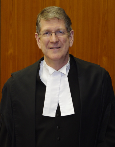 Tall white man in judicial robes. 