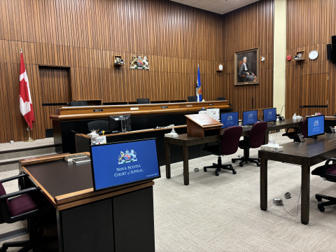 A photo of a Nova Scotia Court of Appeal courtroom. The computer screens show the Court's emblem and the words Nova Scotia Court of Appeal.