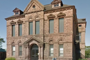 Two-story stone courthouse.