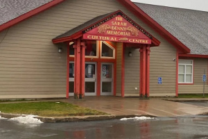 Beige building with red trim. 