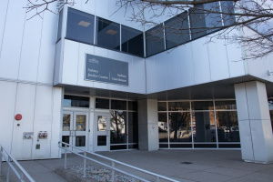 Large white professional building with a courthouse sign above the door.