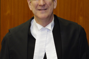 Tall white man in judicial robes. 