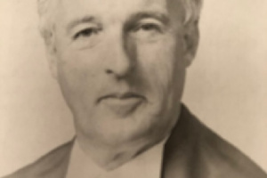 Black and white photo of a judge in robes.